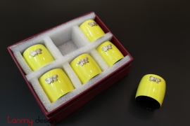 Set of 6 yellow napkin rings attached with butterfly